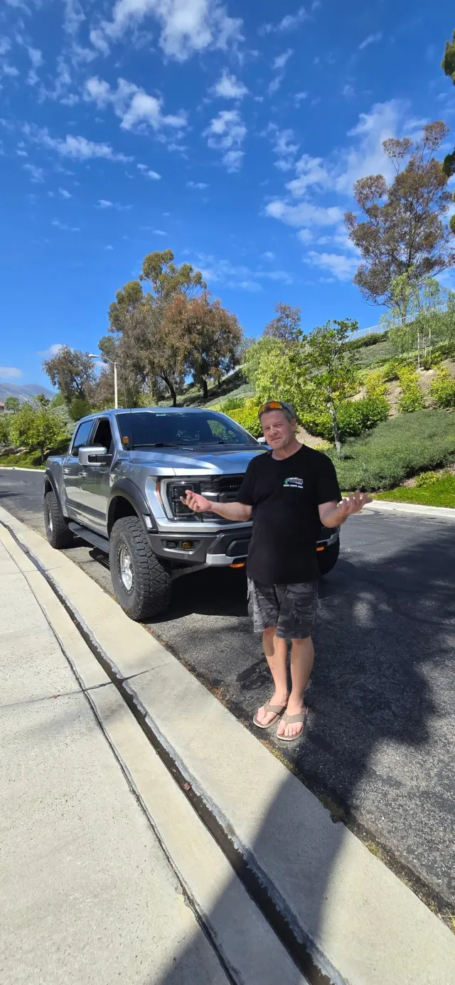 Truck Outfitters Unlimited build walkthrough beside a modified truck