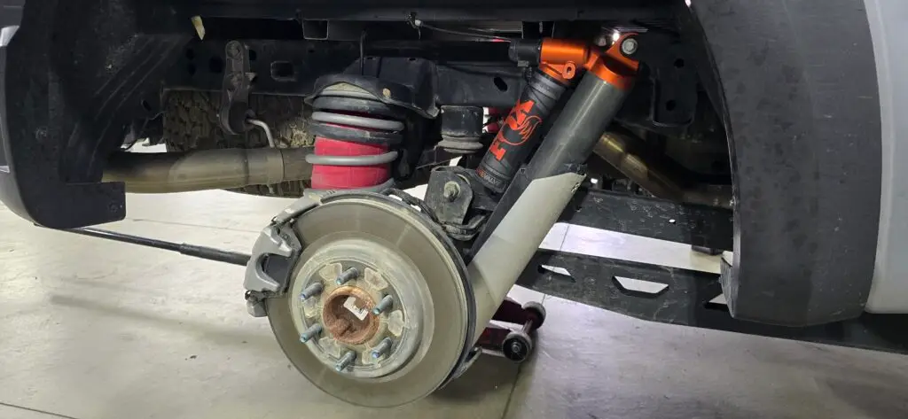 Raptor Gen 3 rear suspension with Foutz shock guards, Air Lift kit, and Eibach HD springs